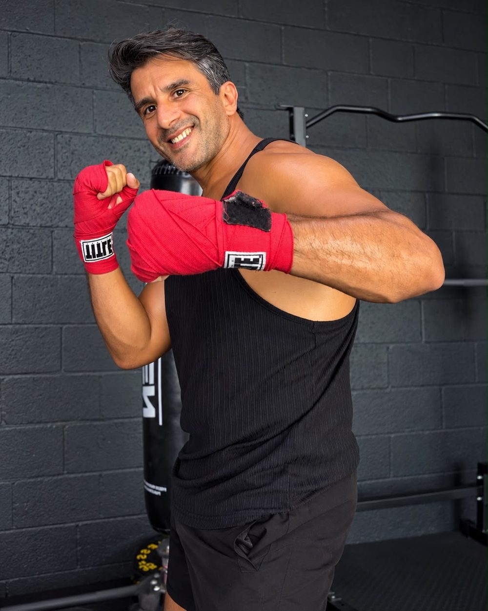 Coach Sebastián in boxing guard with hand wraps